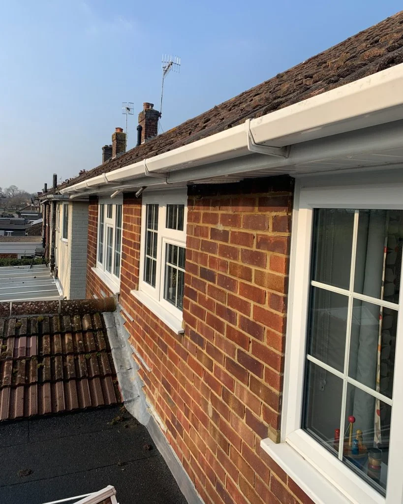 Fascia & Soffit Spray Painting on a residential roofline with white uPVC gutters